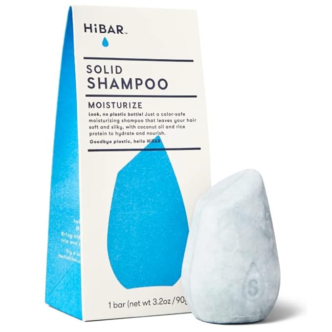 A HiBAR Moisturize solid shampoo bar next to its original packaging