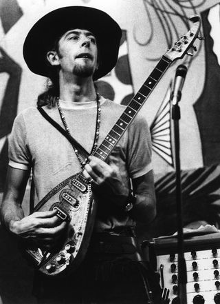 John Mayall performs in the mid 1960s with an unusual three-pickup electric guitar