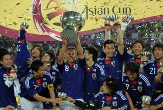 Japan players celebrate with the trophy after winning the Asian Cup in 2011.
