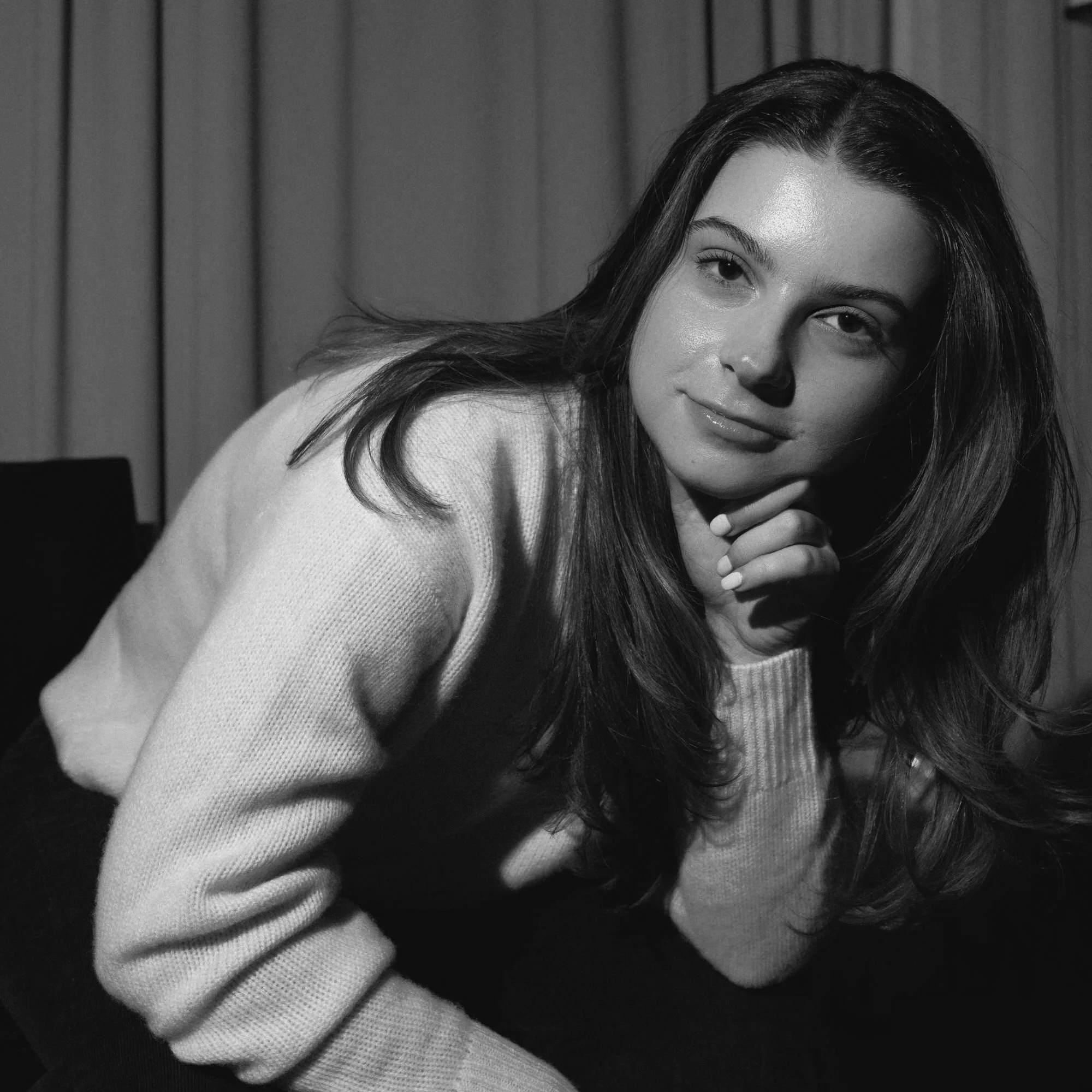 a black and white photo of a white woman in a white turtleneck