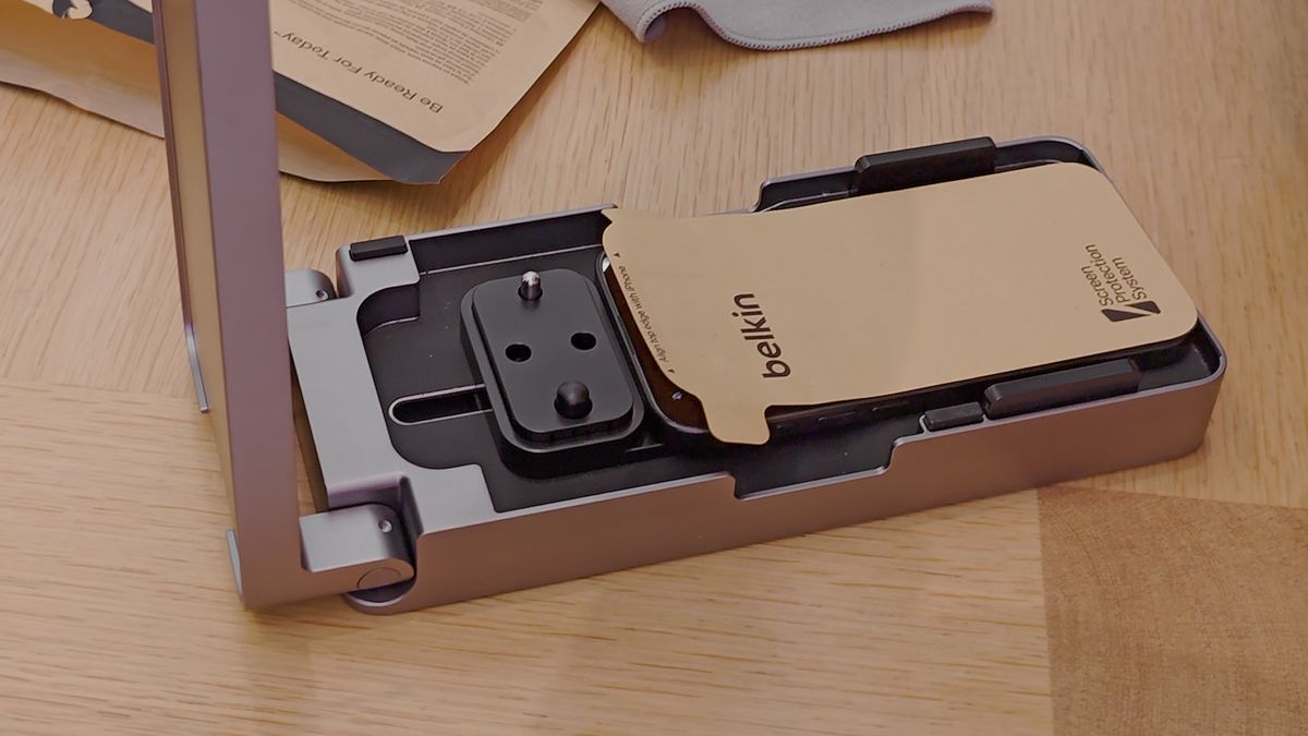The Belkin UltraGlass screen protector being applied to the iPhone 15 Pro Max
