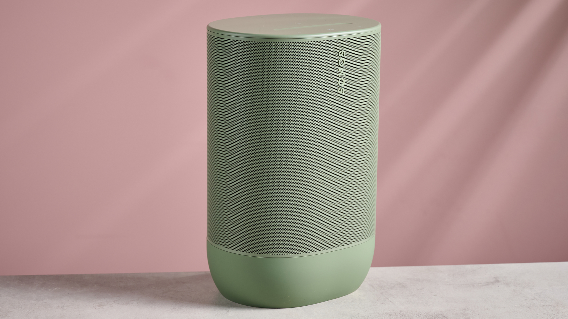 The front of the Sonos Move 2 in front of a pink background.