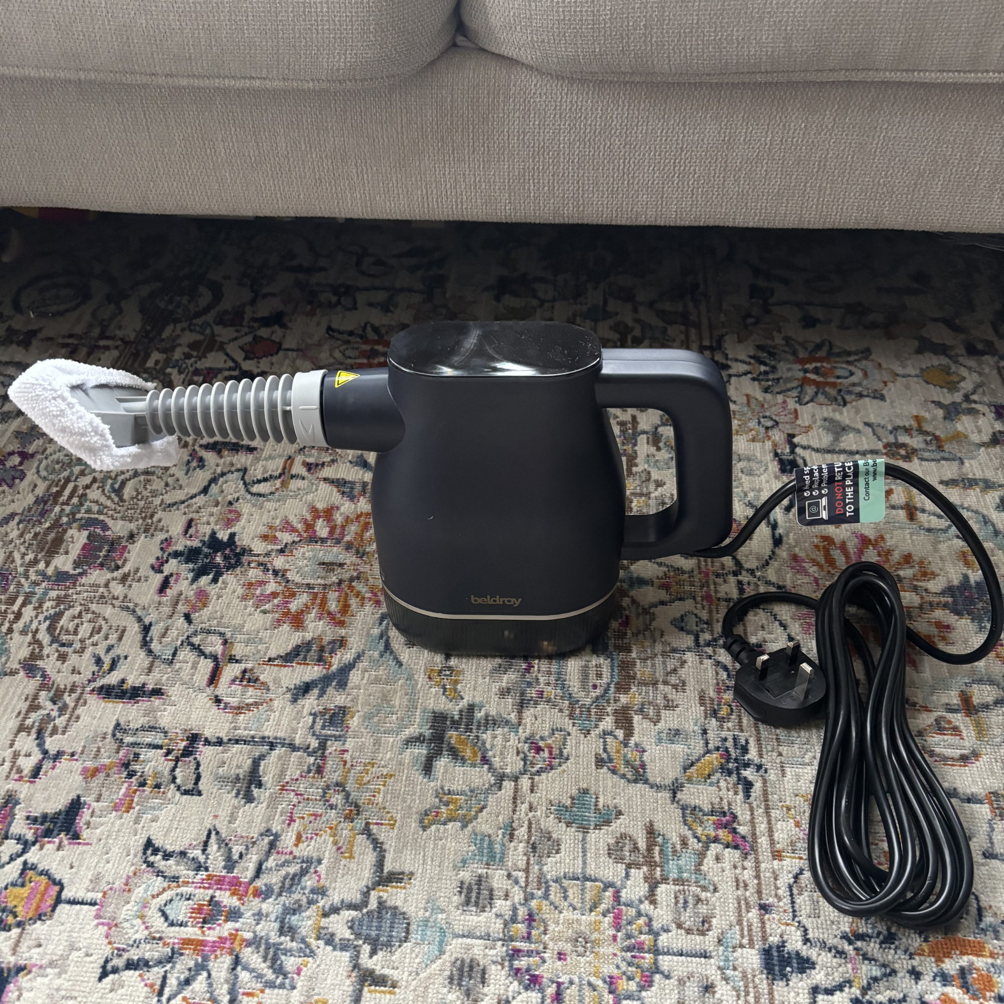 Beldray Digital Handheld Steam Cleaner with upholstery nozzle attached