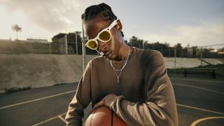 The Oakley Meta HSTN smart glasses being used by a basketball player