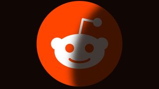 Reddit's orange logo against a black background being 'blacked out' by a dark shadow.
