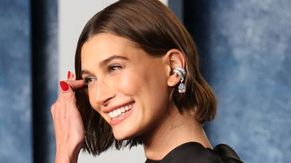 Hailey Bieber with red manicure celebrity nail trend
