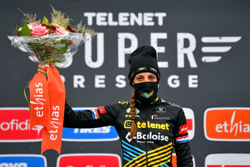 ANTWERPEN BELGIUM DECEMBER 13 Podium Lucinda Brand of The Netherland and Team Telenet Baloise Lions Celebration Mask Covid safety measures Flowers during the 21st Superprestige Gavere 2020 Women Elite Superprestige2021 SPGavere SuperprestigeCX on December 13 2020 in Antwerpen Belgium Photo by Luc ClaessenGetty Images