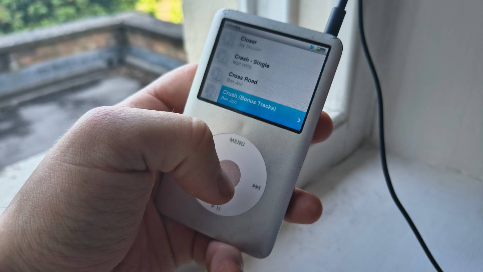 The iPod Classic on a window sill.