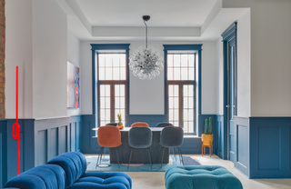 A living-cum-dining room with a blue painted chair rail