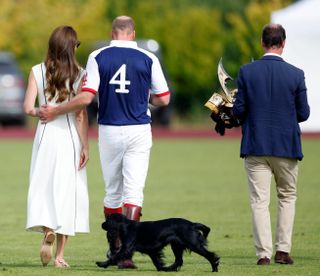 Catherine, Duchess of Cambridge and Prince William, Duke of Cambridge, with their dog 'Orla', attend the Out-Sourcing Inc. Royal Charity Polo Cup at Guards Polo Club, Flemish Farm on July 6, 2022 in Windsor, England.