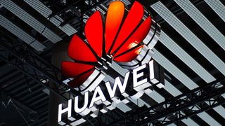 A logo sits illuminated outside the Huawei booth at the SK telecom booth on day 1 of the GSMA Mobile World Congress on February 28, 2022 in Barcelona, Spain.