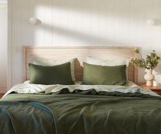 Olive and sage bedding bundle on a bed.