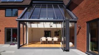 modern conservatory extension with dining area and bifold doors