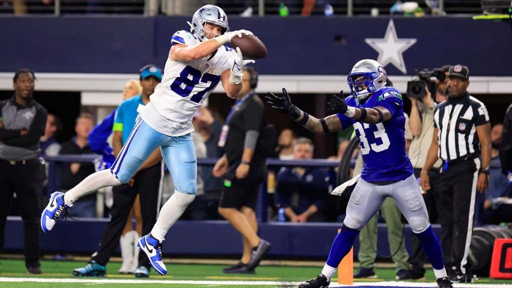 Tight end Jake Ferguson #87 of the Dallas Cowboys makes a catch in the end-zone as safety Jamal Adams #33 of the Seattle Seahawks defends during the 4th quarter of the game at AT&amp;T Stadium on November 30, 2023