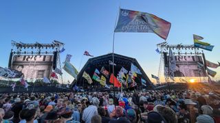 The Pyramid Stage, crowd and flags at the Glastonbury Festival