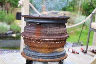 old stack of wheels on a table used as a DIY fire pit