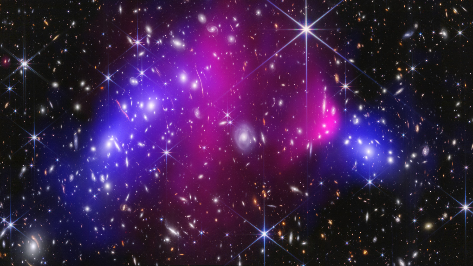 Clouds of purple and blue gas dust collide in deep space