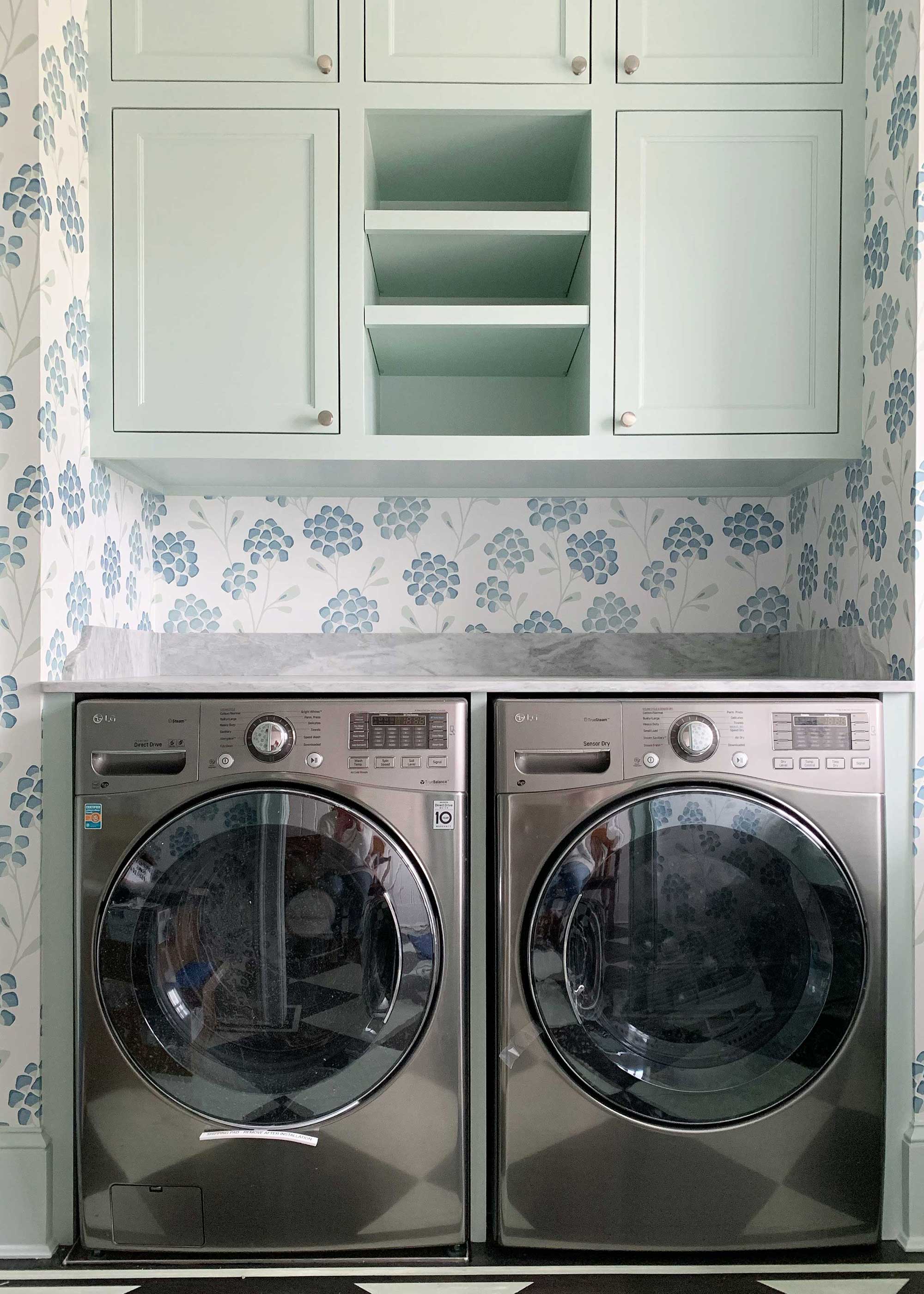 small laundry room with blue floral wallpaper