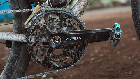 A muddy black crankset