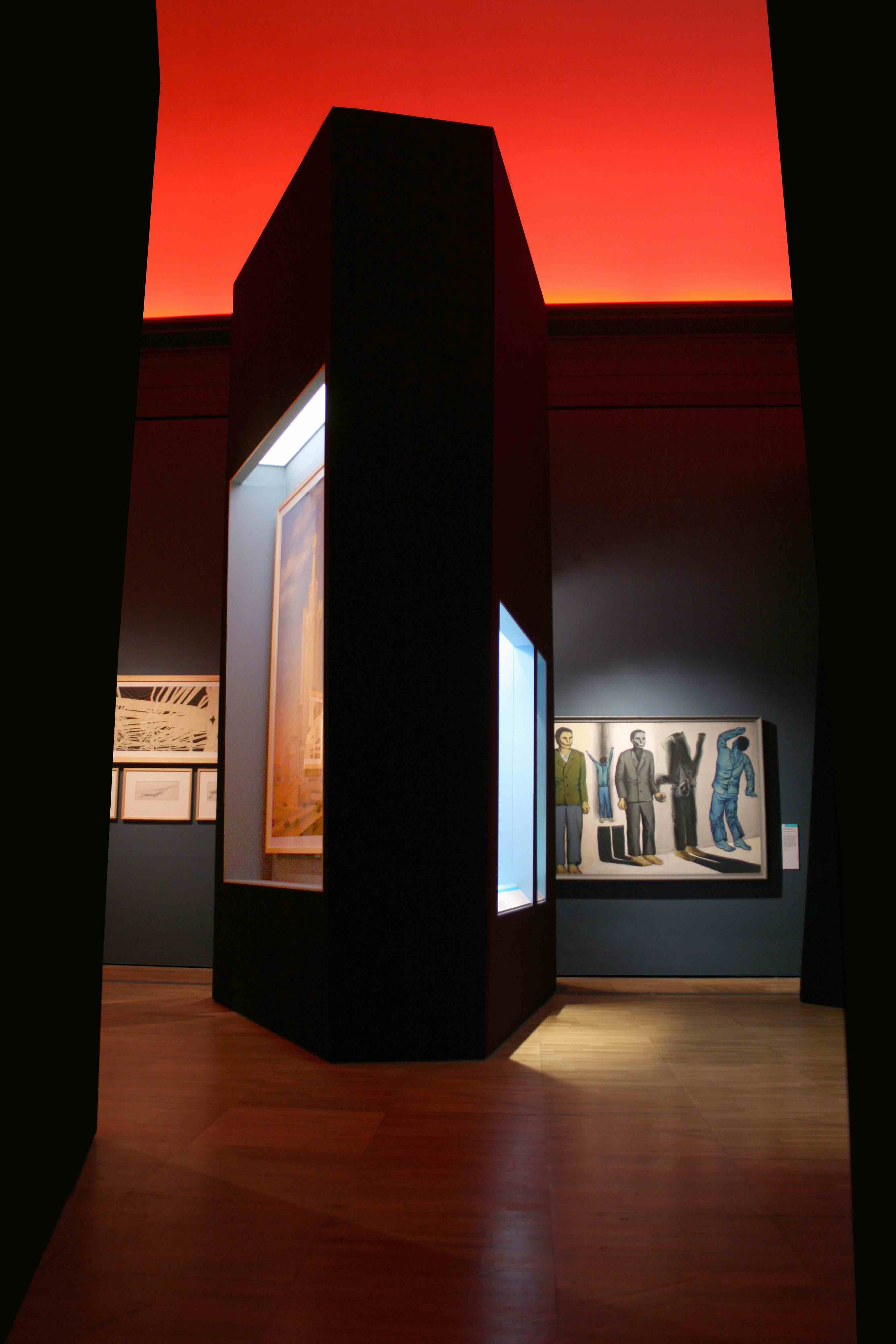 Museum interior with red ceiling and illuminated displays