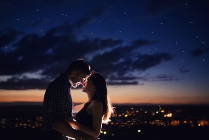 A romantic couple kissing. 