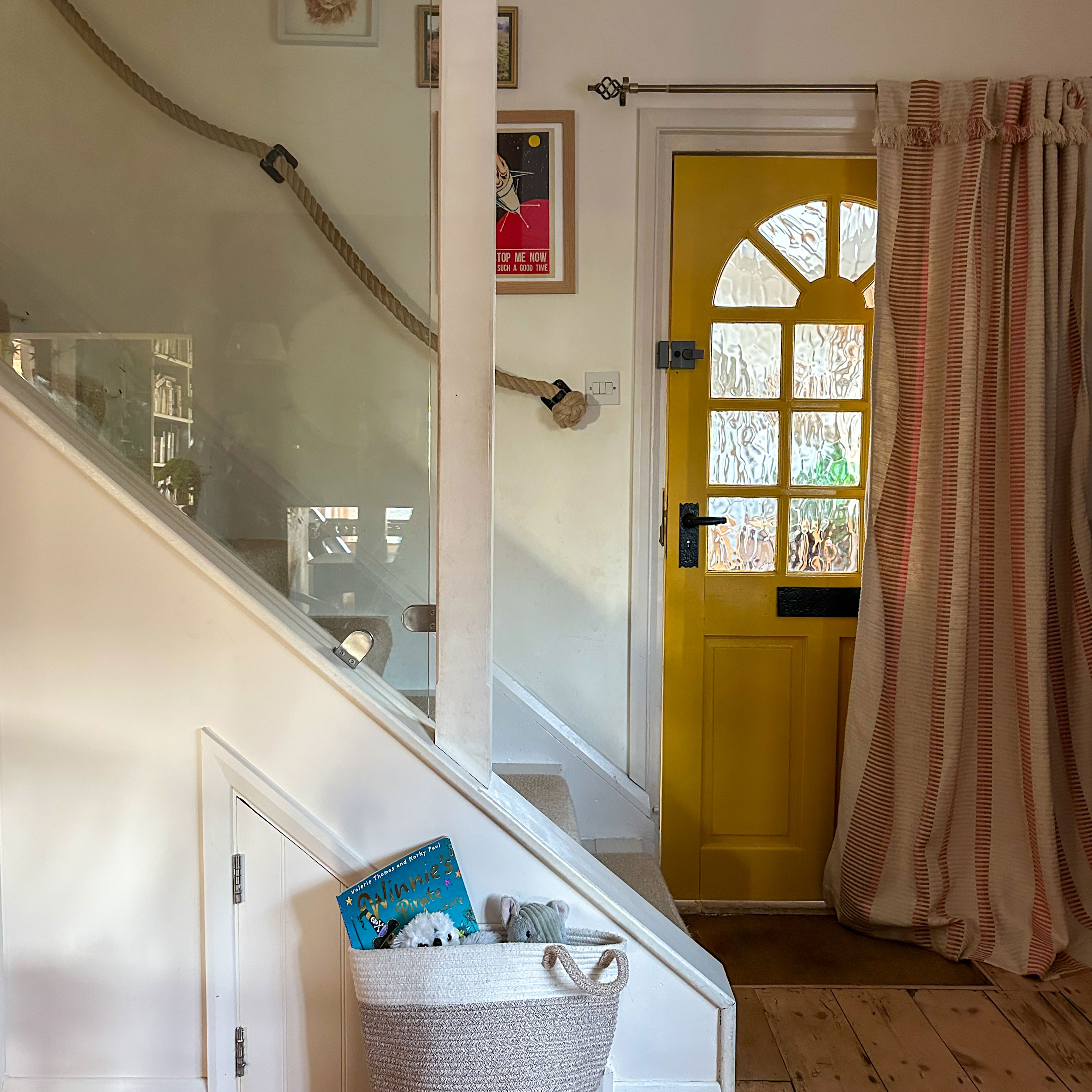 Entrance hall showing interior of yellow door and striped door curtain