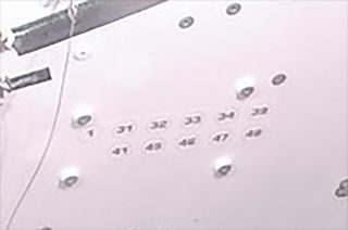 The numbers seen on the forward bulkhead to the right of Orion's docking tunnel are the country calling codes for the nation's who contributed to the Artemis I spacecraft being built.