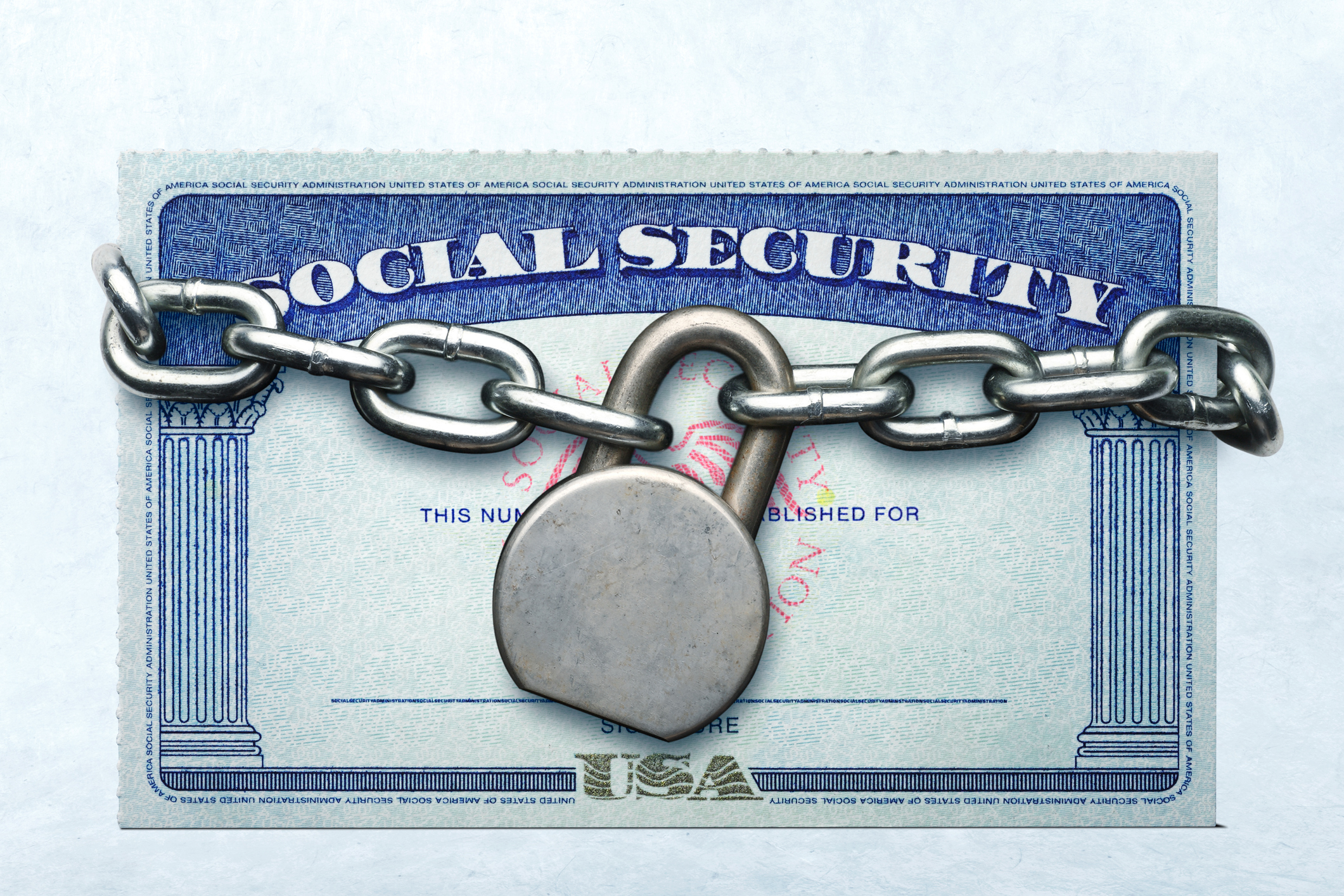 A lock and chain around a Social Security card.