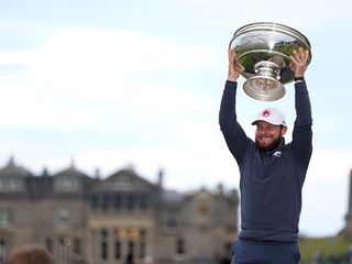 Tyrrell Hatton holding aloft the Alfred Dunhill Links Championship trophy