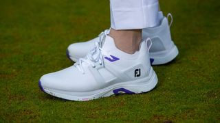 FootJoy Women’s HyperFlex Golf Shoe in its white colorway worn on the golf course