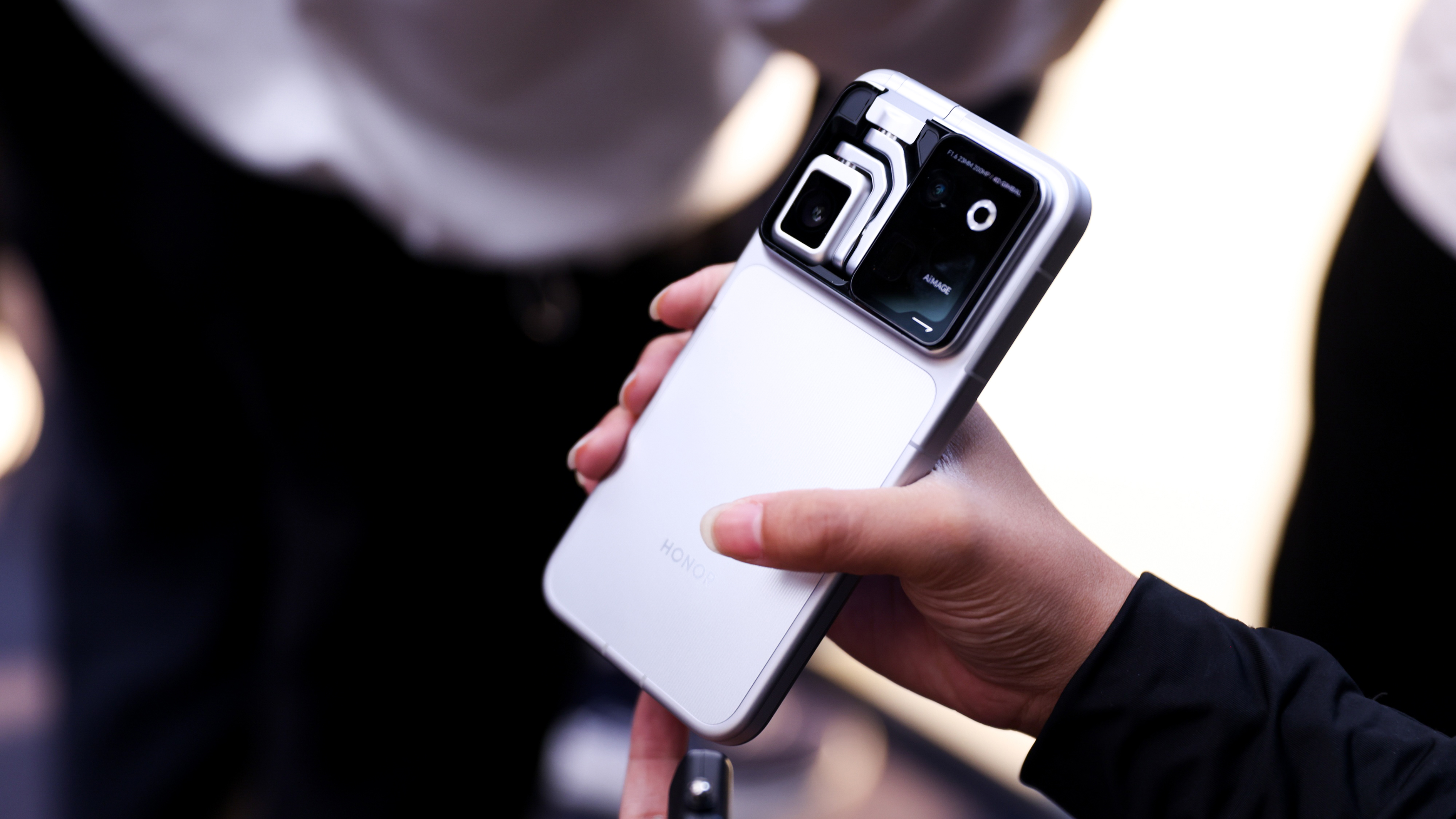 The Honor Robot Phone held in a person's hand with the camera folded