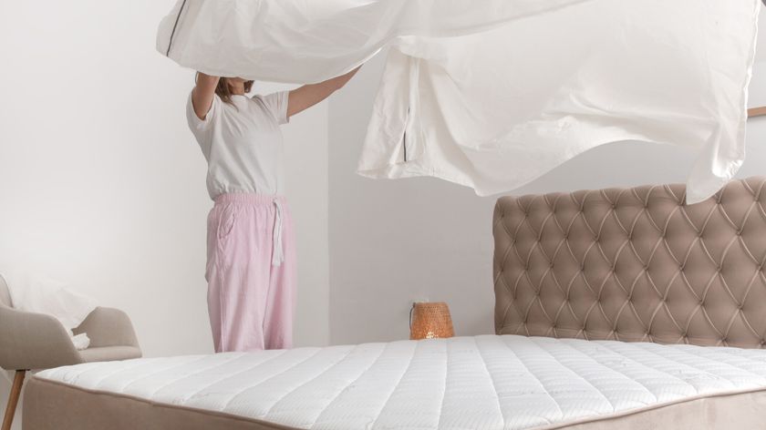 Woman putting on a mattress protector