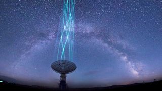 Radio telescope dish pointing at the sky. Milky way band streaks across the sky above.