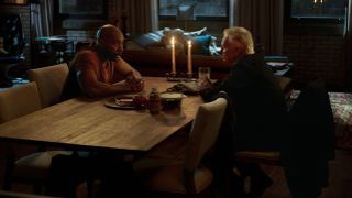 John Watson (Morris Chesnut) sits across a table from Robert Carlye's Sherlock Holmes in Watson season 2