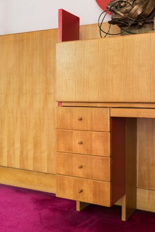 A bespoke chest of drawers with drop down desk