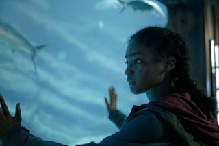 Halle Bush as Allie, with her hands on aquarium glass