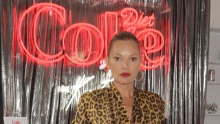 Kate Moss wearing one of the key fall makeup looks, a bold red lip with minimal makeup to accompany it
