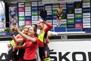 CAMS Basso team taking a selfie with teammate Becky Storrie on the podium