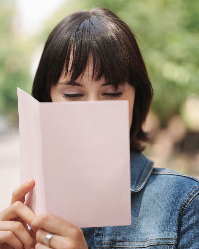A woman reading a greeting card