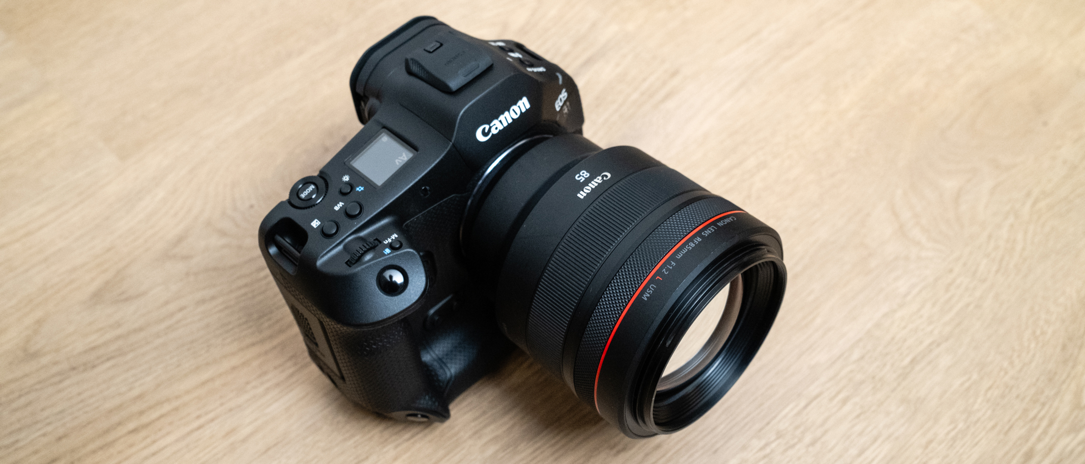 Canon RF 85mm f/1.2L USM attached to a Canon EOS R1 on a wood floor