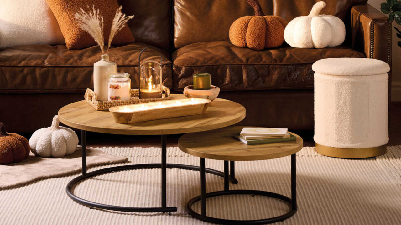 Aldi footstool in tedy. Coffee table with candles, brown sofa and plush pumpkins in orange and cream