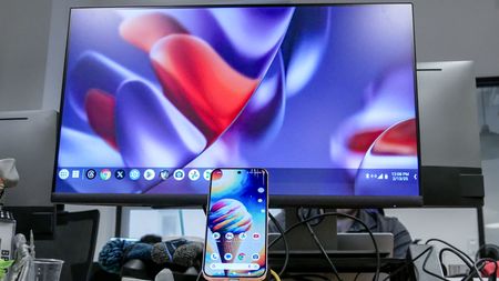 A Pixel 10 phone connected to a monitor showing Google's Desktop Mode on Android