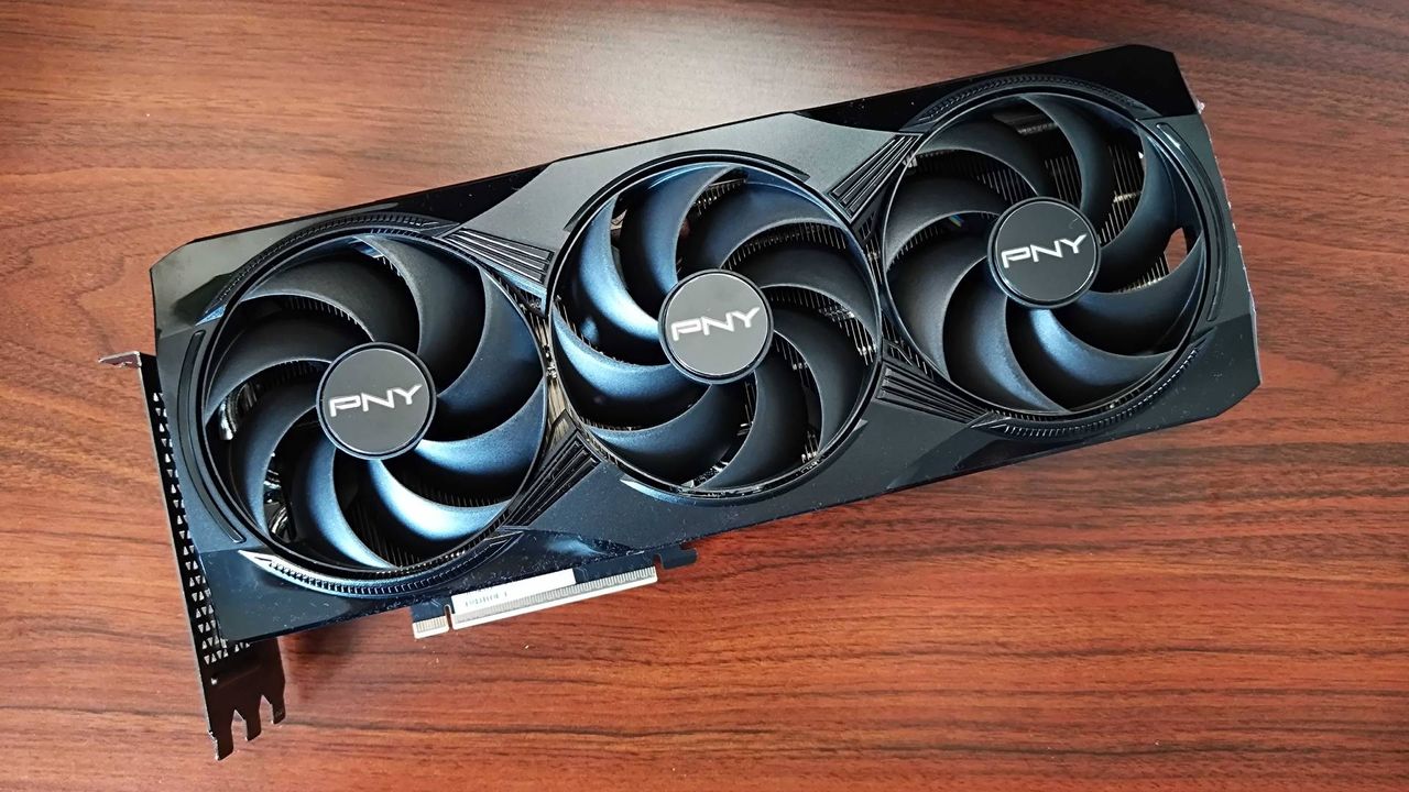 PNY RTX 5080 OC lying flat on woodgrain surface