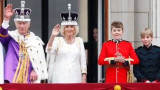 King Charles III, Queen Camilla, Page of Honour Freddy Parker Bowles and Page of Honour Gus Lopes watch an RAF flypast