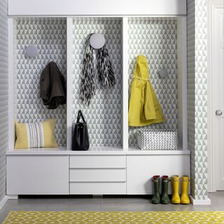 white wall cabinet with jackets and scarf