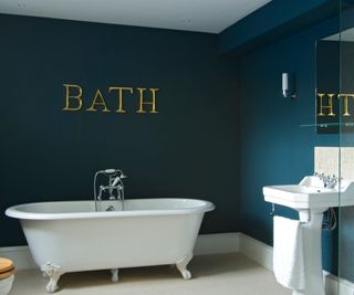 navy bathroom with white bath
