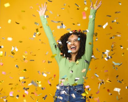 Woman celebrates a big win with confetti falling from above