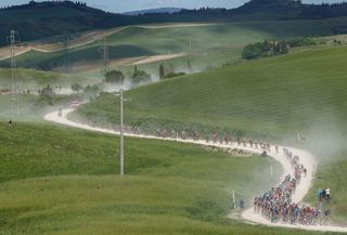The pack rides through the countryside during the eleventh stage of the Giro dItalia 2021 cycling race 162 km between Perugia and Montalcino on May 19 2021 Photo by Luca Bettini AFP Photo by LUCA BETTINIAFP via Getty Images