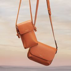 Orange handbags sold at Aspinal of London