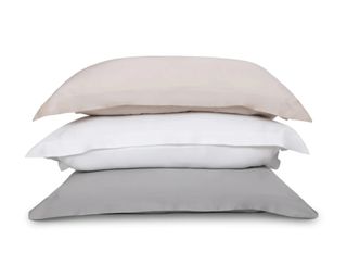 Best silk pillowcases from ethical bedding in a stack of pink, white and wheat cut out